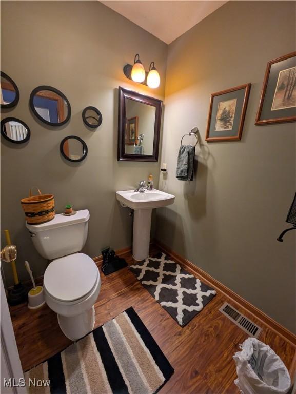 bathroom featuring hardwood / wood-style floors, toilet, and sink