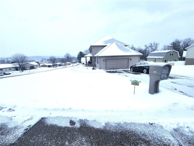 snowy yard with a garage