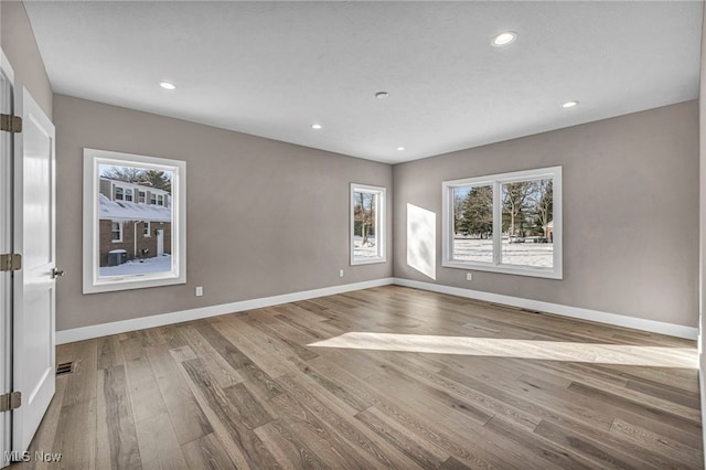 unfurnished room with hardwood / wood-style flooring