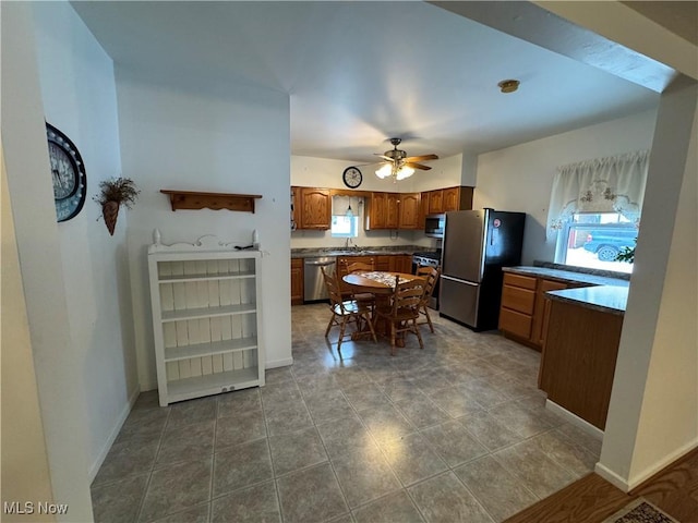 kitchen featuring stainless steel appliances, ceiling fan, and sink