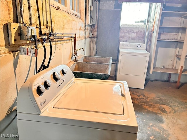 laundry area featuring washer and dryer, sink, and electric panel