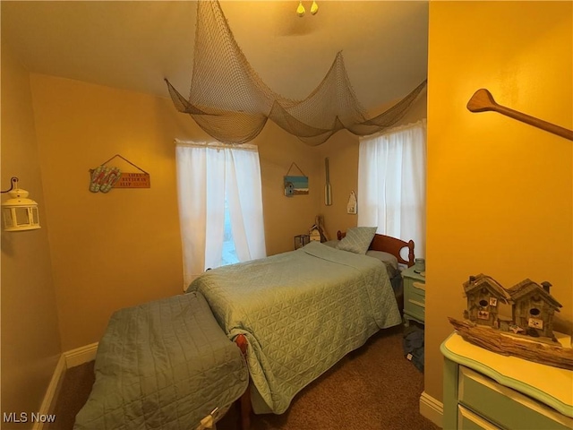 carpeted bedroom featuring multiple windows