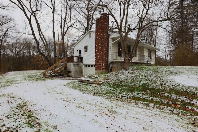 view of snowy exterior with a garage