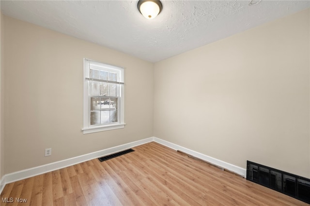 unfurnished room featuring light hardwood / wood-style floors