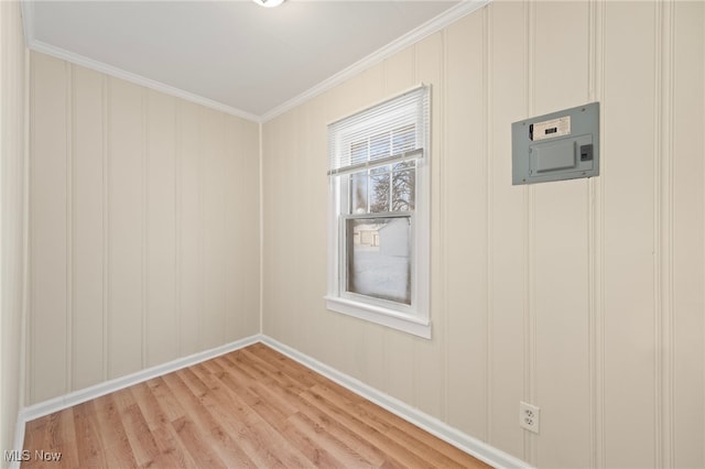 spare room featuring crown molding and light wood-type flooring