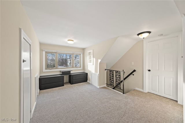 additional living space with light colored carpet