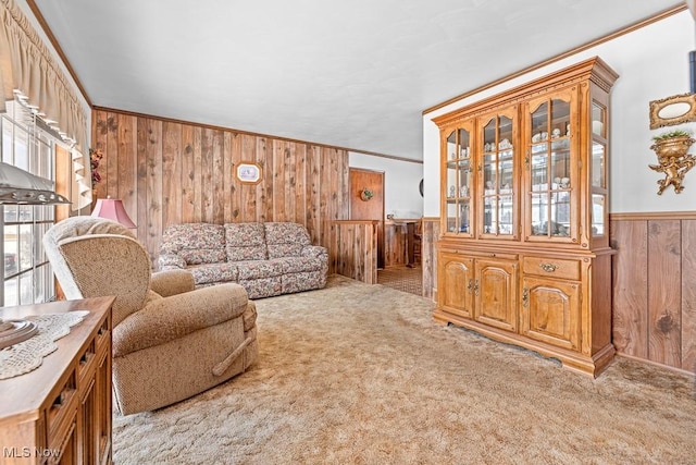 living room featuring light carpet, crown molding, and wood walls