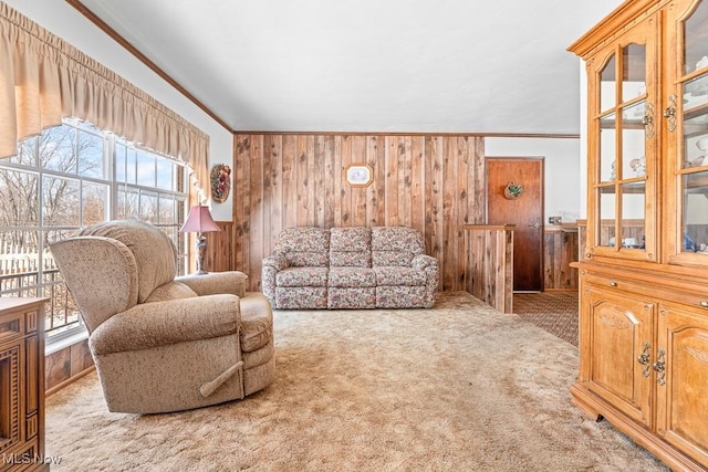 living room with carpet, crown molding, and wooden walls