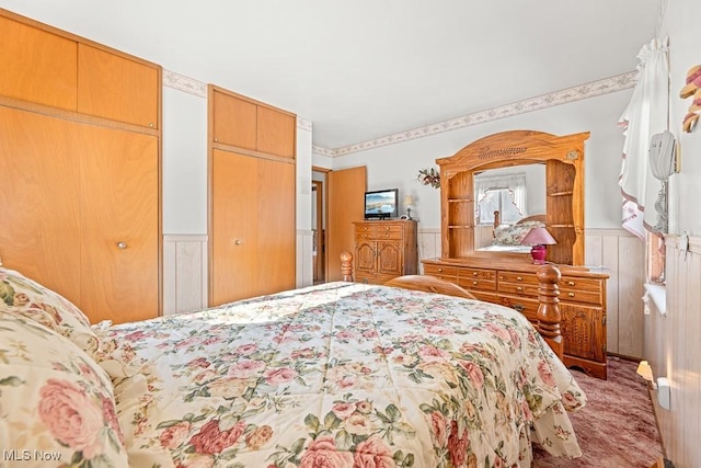 bedroom featuring two closets and carpet flooring