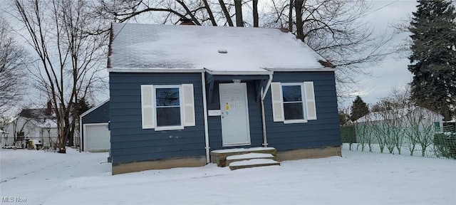 view of front facade featuring a garage and an outbuilding