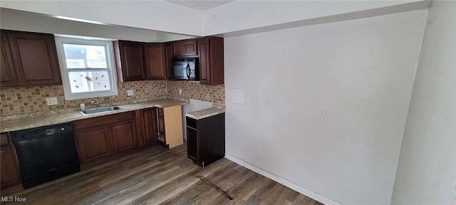 kitchen with sink, light stone counters, dark hardwood / wood-style flooring, decorative backsplash, and black appliances