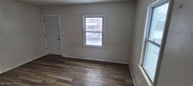 empty room featuring dark hardwood / wood-style flooring