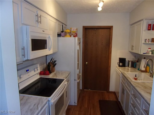 kitchen featuring decorative backsplash, white cabinetry, white appliances, and sink