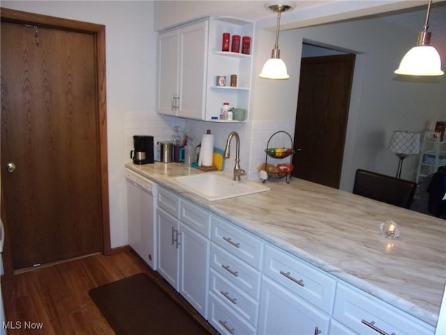 kitchen featuring backsplash, sink, pendant lighting, dishwasher, and white cabinets