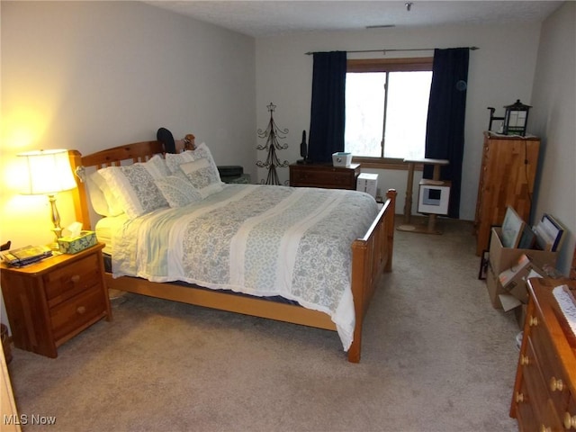 bedroom featuring light carpet