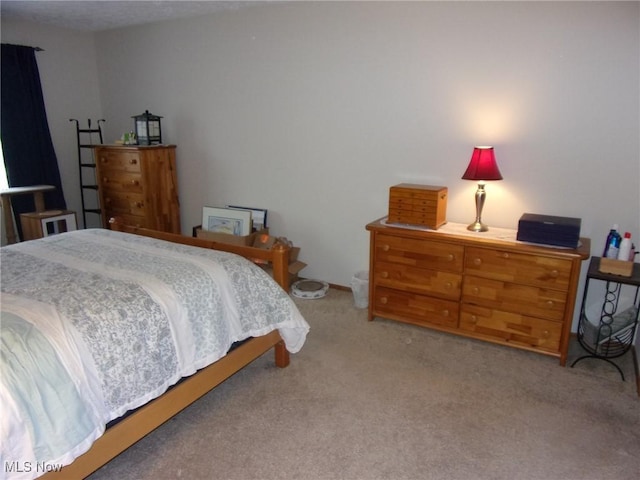 bedroom featuring light carpet