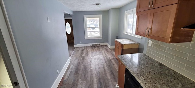 interior space featuring a textured ceiling and dark hardwood / wood-style flooring