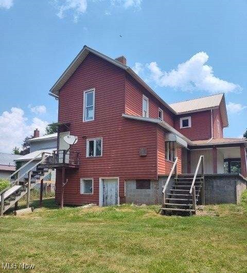 back of house with a lawn