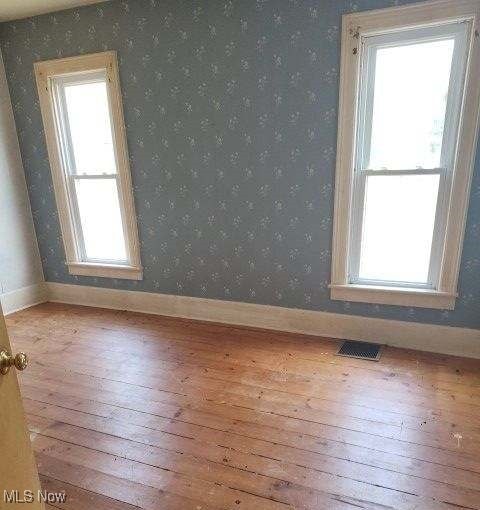 empty room with light hardwood / wood-style floors