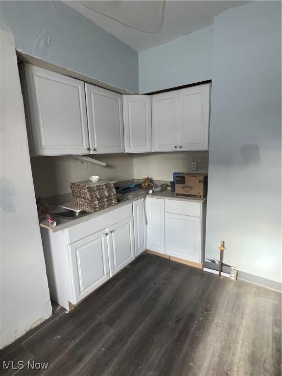 kitchen featuring dark hardwood / wood-style flooring and white cabinets