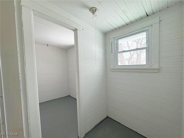 bathroom featuring wood walls