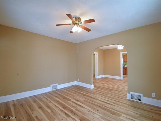 spare room featuring ceiling fan and light hardwood / wood-style flooring