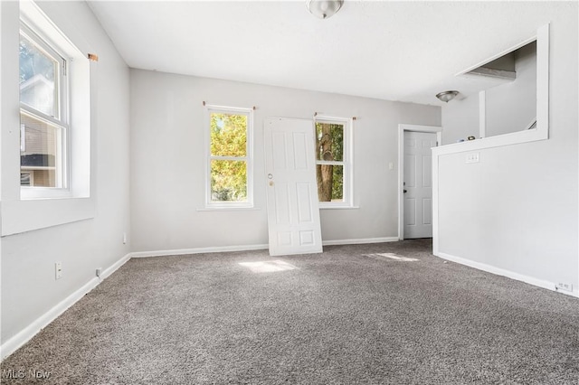 carpeted empty room with a wealth of natural light