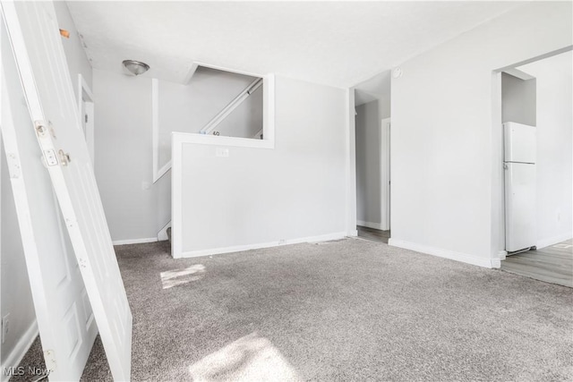 unfurnished living room featuring carpet flooring