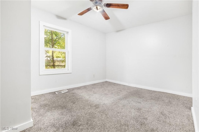 carpeted spare room with ceiling fan