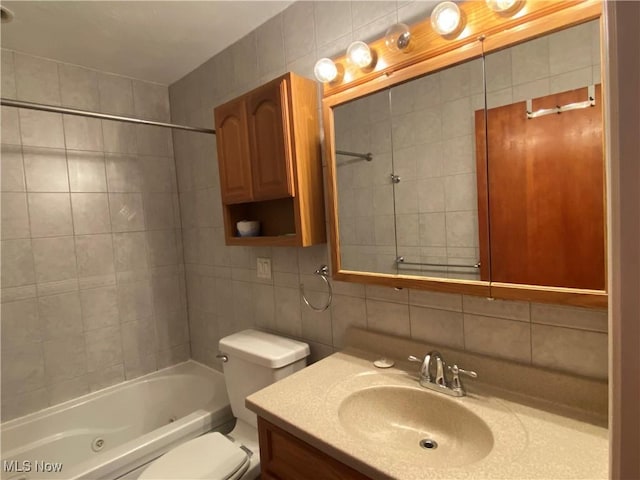 full bathroom featuring backsplash, vanity, tile walls, washtub / shower combination, and toilet