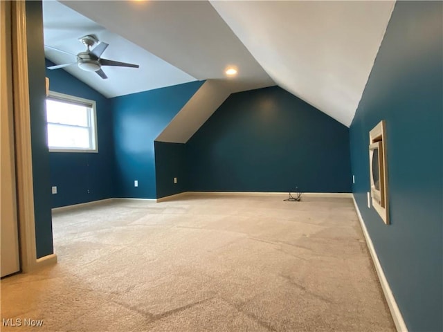 additional living space with ceiling fan, light carpet, and vaulted ceiling