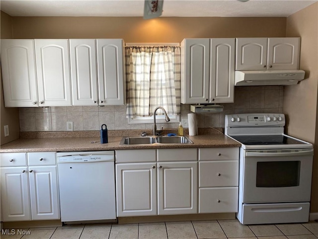 kitchen featuring white appliances, white cabinets, sink, decorative backsplash, and light tile patterned floors