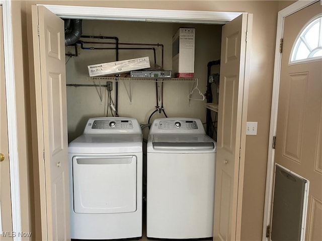 washroom with washing machine and clothes dryer