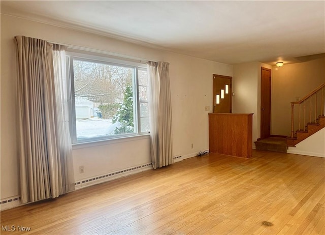 spare room with light hardwood / wood-style floors and baseboard heating