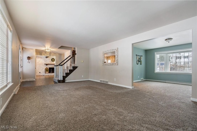 unfurnished living room featuring a fireplace and dark carpet