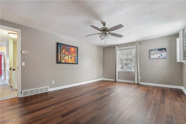 spare room featuring ceiling fan and dark wood-type flooring