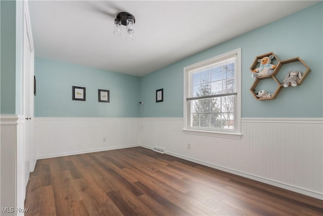 spare room featuring dark hardwood / wood-style floors