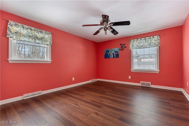 unfurnished room with dark hardwood / wood-style floors and ceiling fan