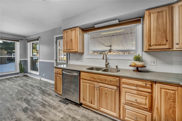 kitchen featuring ceiling fan, dishwasher, sink, light hardwood / wood-style flooring, and backsplash