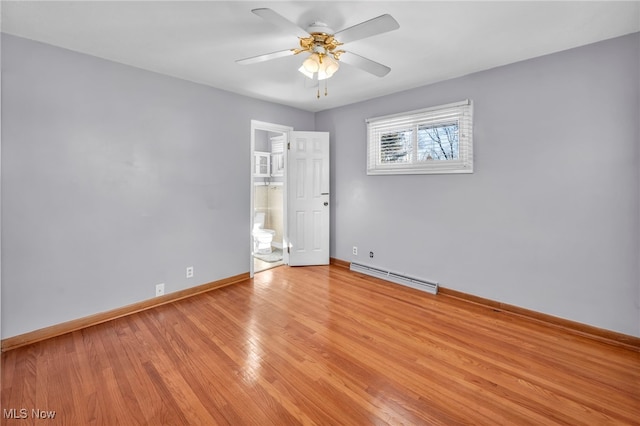 spare room featuring baseboard heating, ceiling fan, and light wood-type flooring