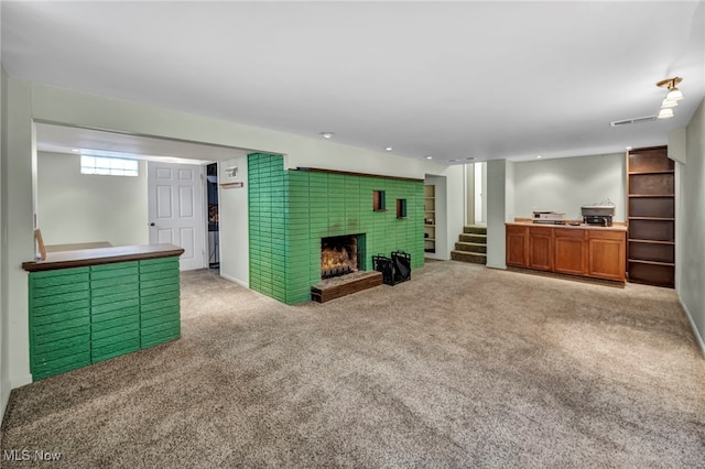 carpeted living room with a brick fireplace