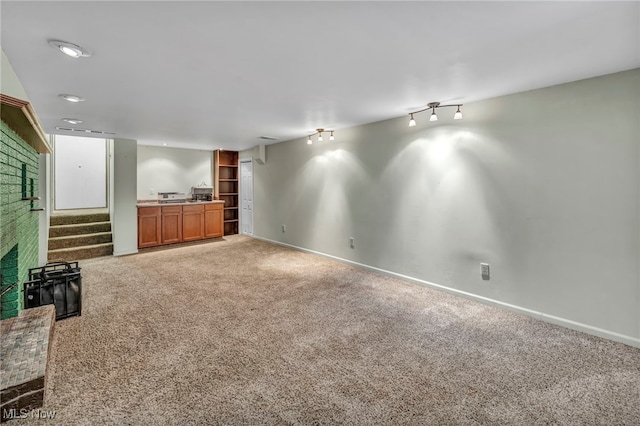 unfurnished living room with carpet flooring and a fireplace