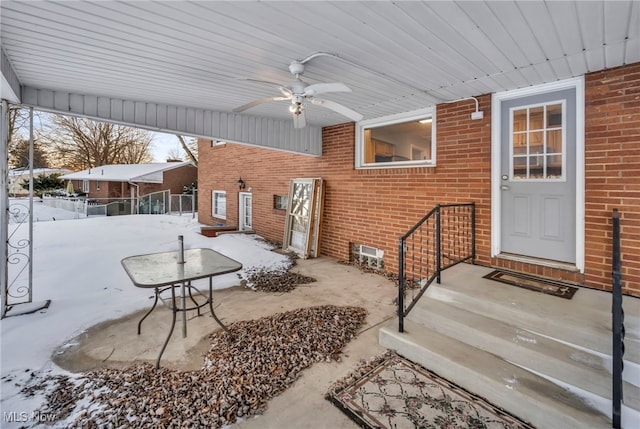 snow covered patio with ceiling fan