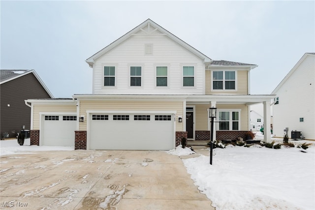 front facade featuring central AC and a garage