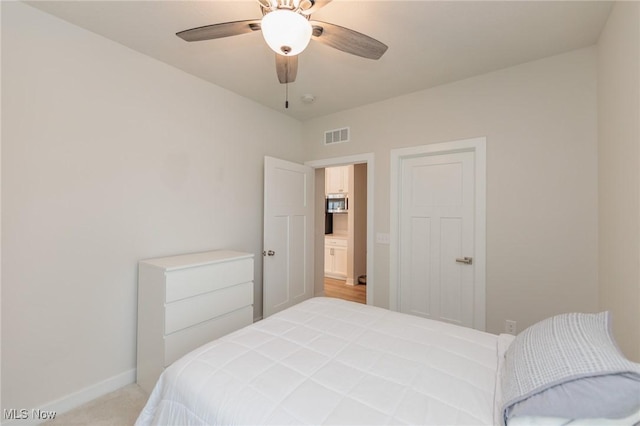 bedroom featuring light colored carpet and ceiling fan