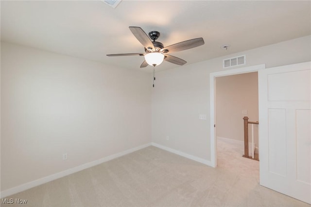 carpeted empty room featuring ceiling fan