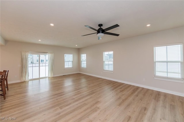 unfurnished room with ceiling fan and light wood-type flooring