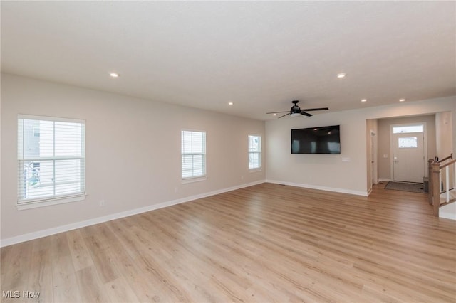 unfurnished living room with light hardwood / wood-style flooring and ceiling fan