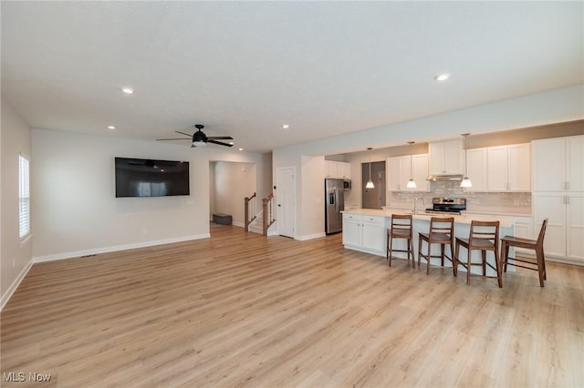 interior space featuring light wood-type flooring and ceiling fan