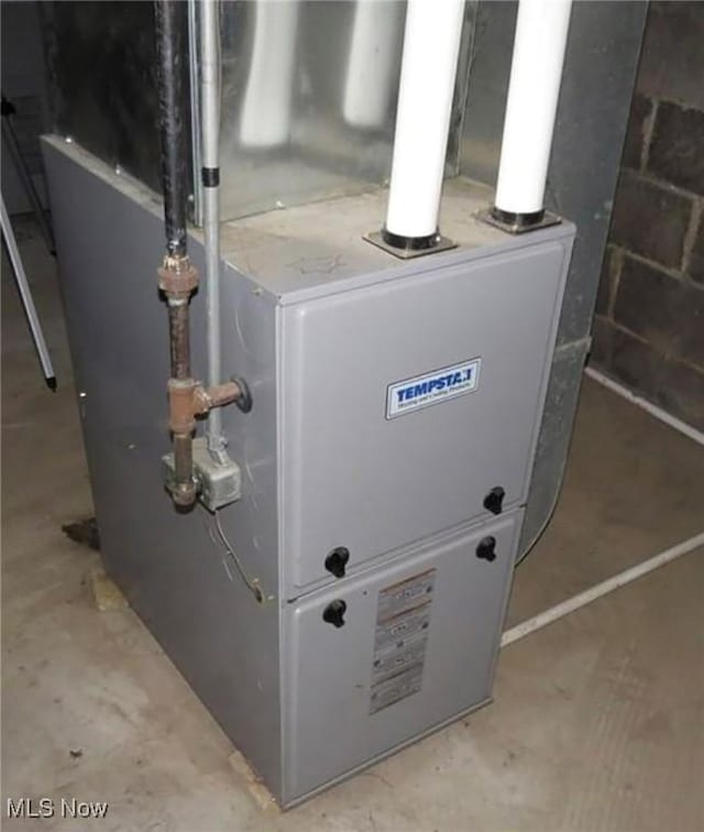 utility room with heating unit